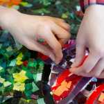 Dzantik'i Heeni Middle School students glue colored glass pieces to form a three by eight-foot mosaic based on a painting by Dutch artist Vincent van Gogh on Wednesday. Manning is spending two weeks working with the middle school students on producing two glass mosaic panels as part of the Artist in the Schools Program.