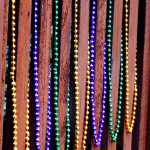 Mardi Gras beads decorate a fence, January 14, downtown Juneau.