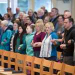 Community members hold hands as they sing "We Shall Overcome" during the Dr. Martin Luther King Jr. 2016 Community Celebration at the St. Paul's Catholic Church on Monday.