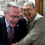 Sen. Dennis Egan, D-Juneau, left, receives an enthusiastic greeting by Rep. Benjamin Nageak, D-Barrow, on the first day of the 29th Legislature at the Capitol in Juneau on Tuesday, Jan. 19, 2016.