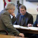 Sen. Pete Kelly, R-Fairbanks, co-chair of the Senate Finance Committee, second from left, speaks with Legislative Finance Division Director David Teal, right, as James Armstrong, left, and Brett Huber, both staff to Sen. Kelly, listen during a during a break in the committee meeting on Tuesday. Pat Pitney, director of the Office of Management and Budget, was presenting Gov. Bill Walker's budget proposal.