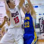 Juneau-Douglas's Kaleb Tompkins shoots against Kodiak's Keith Osowski during their game at JDHS on Friday. Juneau won 75-40.