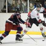 Juneau-Douglas' Quin Gist, right, looks to pass against North Pole's Kole Kuykendal in JDHS's final home game of the season on Friday.
