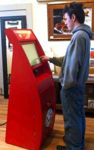 In this Sept. 30, 2014 photo, Greg Klupar interacts with a kiosk which could be used to dispense raffle and lottery tickets to buyers in Skagway.