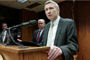 Dean Williams speaks to reporters after Gov. Bill Walker appointed him to be the new commissioner of the Alaska Department of Corrections on Thursday. Walker is shown behind Williams' shoulder.