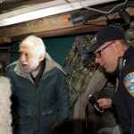 Landlord Marcel Prato, left, reacts as he and Sitka Police Lt. Lance Ewers, right, look at tunnels dug under a trailer owned by Prato, Thusday, January 28, 2016, in Vitskari trailer park. (Sentinel Photo by James Poulson)