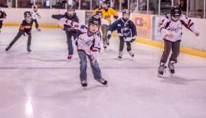 Cam Kovach leads teammates down the stretch in a clockwise lap of Second Annual Skate-a-Thon sponsored by JDIA's Squirt Division. Kovach skated 126 laps, almost 11.5 miles.