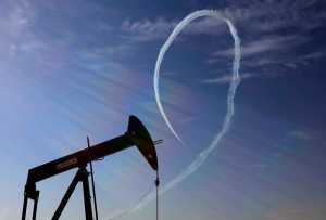 In this Jan. 23 photo, an oil pump stands as the Saudi Hawks Aerobatic Team of the Royal Saudi Air Force performs during the Bahrain International Airshow in Sakhir, Bahrain.