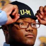 Paramus Catholic High School defensive tackle Rashan Gary, a top high school football recruit, adjusts a Michigan hat during a school rally following his televised signing announcement Wednesday in Paramus, New Jersey.
