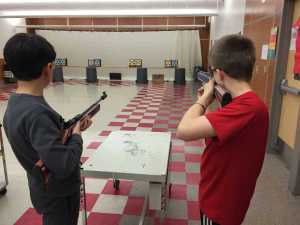 Dzantik'i Heeni student Ian Bugayong, left, and Floyd Dryden student Tim Degener compete while shooting Daisy Avanti 888 Medalist Co2 air rifles with .177 caliber pellets at 10 meter targets. The pellets travel 580 feet per second. This is the fifth year Juneau's middle schools have competed in air rifle competitions.
