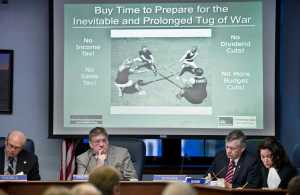Senate State Affairs Committee members John Coghill, R-North Pole, left, Bill Stoltze, R-Chugiak, Charlie Huggins, R-Wasilla, and Lesil McGuire, R-Anchorage, listen to UAA Professor Emeritus in Economics, Scott Goldsmith about possible budget solutions during a hearing for SB 128 at the Capitol on Thursday.