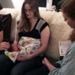 Madi Nolan-Grimes, clinical director of The Juneau Family Health and Birth Center, speaks to parents Lynn and Chad Burnett during an in-home visit with their newborn, Johannes Ulyess Burnett, last month.