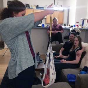 Madi Nolan-Grimes, clinical director of The Juneau Family Health and Birth Center, weighs newborn Johannes Ulyess Burnett during an in-home visit with new parents Lynn and Chad Burnett. The Juneau Family Health and Birth Center recently received a grant that funds a new program that will extend postpartum support to more mothers and their families.