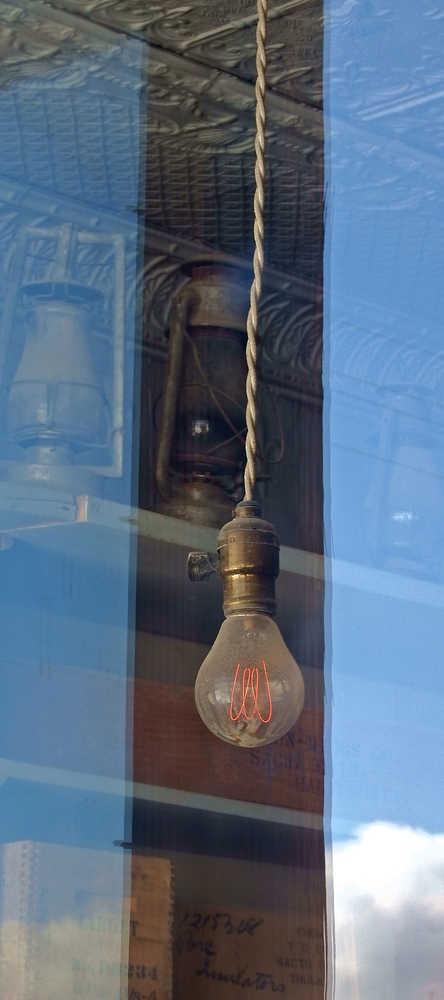 A lightbulb hangs in a window in the mining ghost town of Bodie, California.