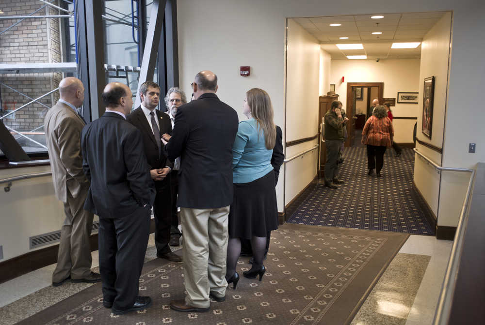 House minority members huddle outside of the House of Representatives chambers at the Capitol on Monday after a surprise measure, House Concurrent Resolution 23, that would suspend some legislative rules that govern committee meetings.