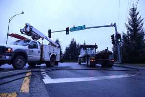A telephone wire for 700 Juneau phone lines is sprawled across the left turn lane on Vintage Drive Wednesday after an Arrow Refuse truck's garbage lift hooked on the line, bringing it down and traffic to a stop.