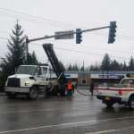 A telephone wire for 700 Juneau phone lines is sprawled across the left turn lane on Vintage Drive Wednesday after an Arrow Refuse truck's garbage lift hooked on the line, bringing it down and traffic to a stop.