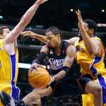 FILE - In this Dec. 25, 2001, file photo, Philadelphia 76ers' Allen Iverson, center, throws a wrap-around pass between Los Angeles Lakers' Mark Madsen, left, and Robert Horry in the second quarter of an NBA basketball game, in Los Angeles. This year's Hall of Fame class includes a star-studded field of potential finalists, including Shaquille O'Neal, Yao Ming and Allen Iverson. That trio should be a lock to get in. (AP Photo/Kevork Djansezian, File)
