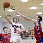 Juneau-Douglas' Treyson Ramos drives to the basket against Sitka's Oliver Moore-Baker, right, and Braden Case at JDHS on Thursday. JDHS won 71-60.