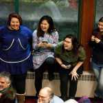 A Feb. 12 photo, a group of fans watch Byron Nicholai, a performer from the Western Alaska village of Toksook Bay, sing and play his drum in Juneau.