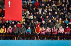 In this Tuesday photo, North Koreans sit behind a banner with an exclamation mark during a figure skating performance held as part of celebrations on the "Day of the Shining Star" or birthday anniversary of late North Korean leader Kim Jong Il in Pyongyang, North Korea.