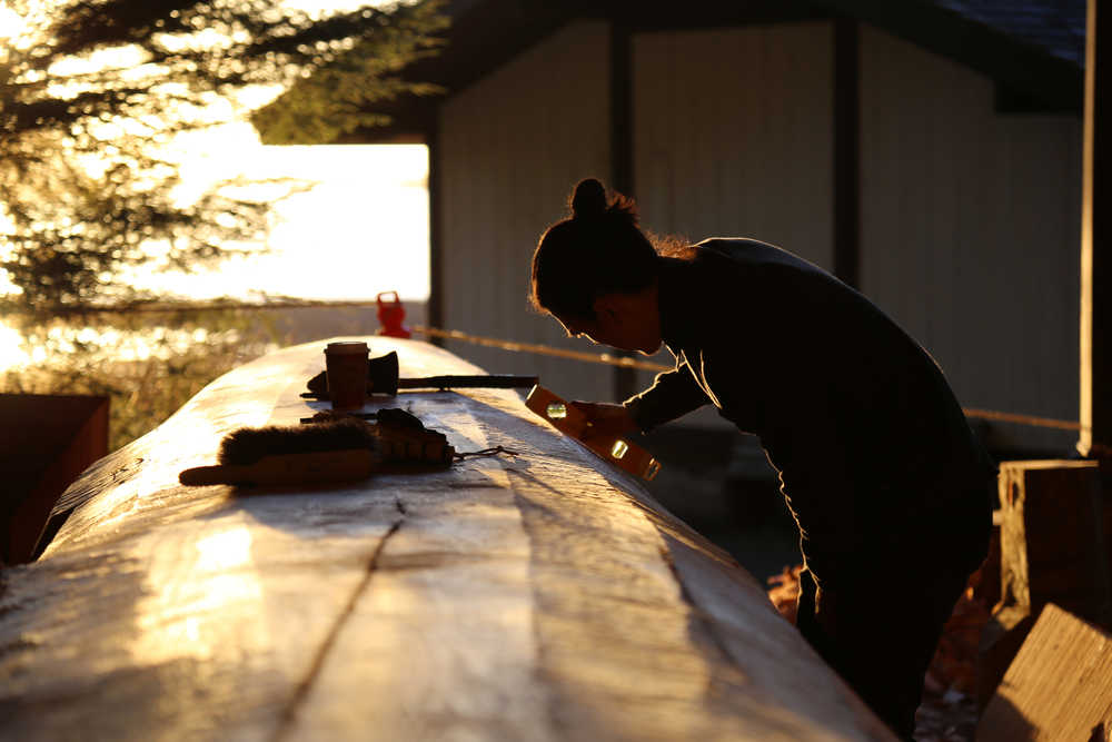 Haida carver TJ Young has been working on the canoe every day. All the carvers welcome visitors - and coffee. (National Park Service | Erin Fulton)