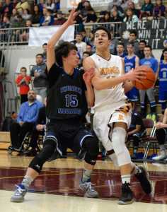Thunder Mountain High School senior Noah Reishus-O'Brien (15) guards Ketchikan High School senior Jason James (11) on Saturday during the Falcons 70-45 loss to the Kings in the Clarke Cochrane Gym.