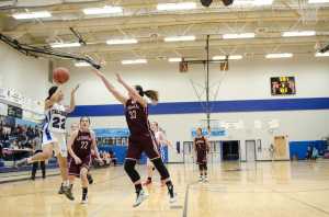 Thunder Mountain's Siniva Maka shoots against Ketchikan's Courtney Kemble during their game Friday night at TMHS. Ketchikan won 53-37 on Friday, and 55-33 on Saturday.