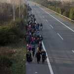 Refugees and migrants make their way to the border with Macedonia near the northern Greek village of Idomeni on Tuesday.