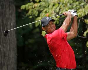 In this Aug. 23, 2015 photo, Tiger Woods watches his tee shot on the second hole during the final round of the Wyndham Championship golf tournament in Greensboro, North Carolina.