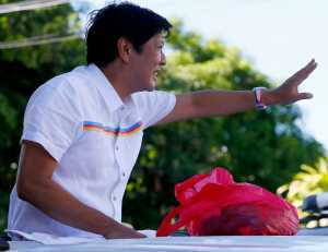 In this Feb. 22 photo, vice-presidential candidate Sen. Ferdinand "Bongbong" Marcos Jr. waves to supporters during his campaign sortie in Muntinlupa city, southeast of Manila, Philippines.