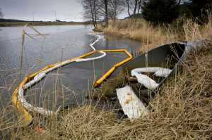 Oil booms and absorbent pads are deployed at Twin Lakes downhill from an home heating oil tank failure in Mountainside Estates on Feb. 3.