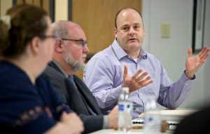 Dr. Andre Rosay presents the results of the 2015 Alaska Victimization Survey to the Alaska Council on Domestic Violence and Sexual Assault during their meeting in Juneau on Thursday. Lauree Morton, Executive Director for the CDVSA, left, and Richard Irwin, Chair of the CDVSA, listen during the meeting held in the Gold Belt Building.