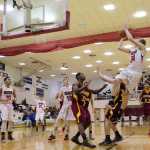 Juneau-Douglas's Erik Kelly shoots against Mt. Edgecumbe's Tesfaye Herrmann during their game Friday night at JDHS. Juneau wins 70-63.