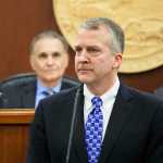 Sen. Dan Sullivan stands at the podium in the state House for his annual address to a joint session of the Alaska Legislature on Monday, Feb. 29, 2016, in Juneau, Alaska. The Republican Senator spoke of challenges facing Alaska and the U.S. as oil prices continue to fall and military activity in the Arctic grows. (AP Photo/Rashah McChesney)