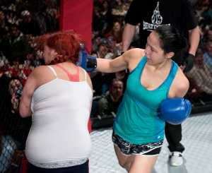 Kylee Larson punches first-time fighter Natasha Roberts during a boxing bout. Larson defeated Roberts.