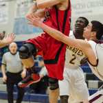 Gustavus's Jonah Patrick shoots against Hoonah's Antonio Phillips, right, and Emmanuel Budke, back, during their Region V 1A Tournament at TMHS. Hoonah won 71-31.