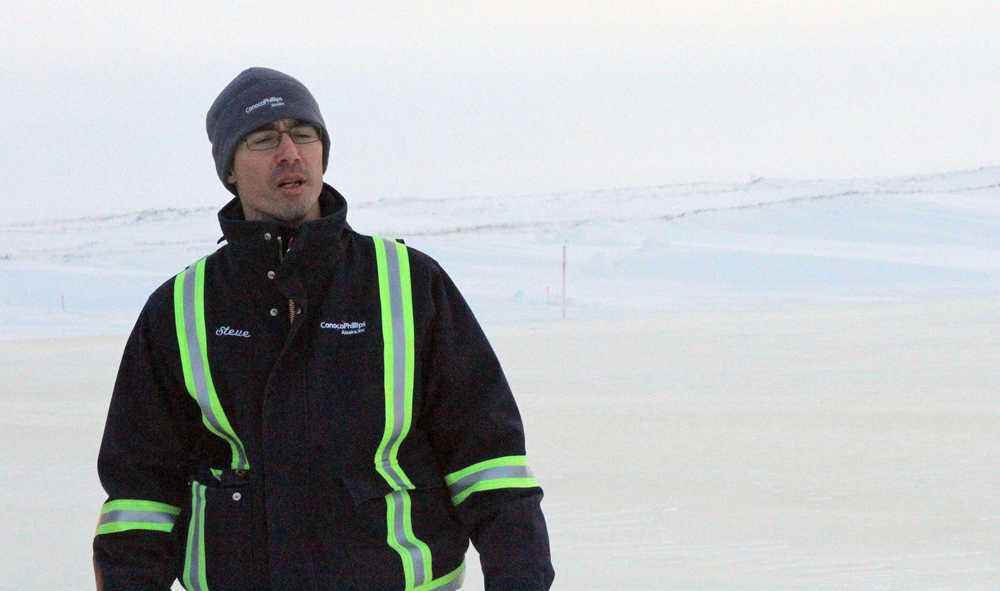 This Feb. 9 photo shows Steve Thatcher, the Alpine operations manager for ConocoPhillips, standing on an ice bridge near the CD5 drilling site on Alaska's North Slope.