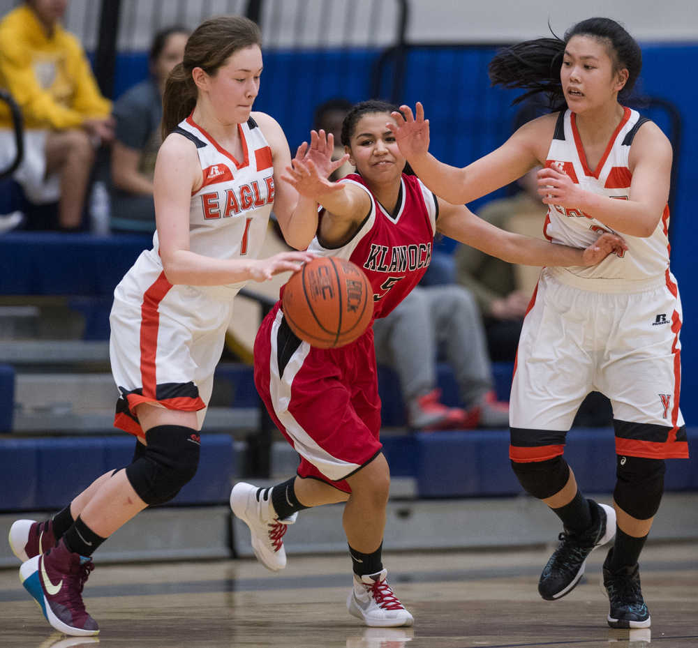 Klawock's Raven Chafin, center, is stripped of the ball by Yakutat's Shaye Jensen, left, and Dani Go during the 1A Region V Basketball Championship game on Friday. Klawock won 37-35.