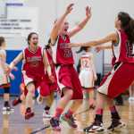 Klawock's Ashley Huffine, center, celebrates with teammates Taya Marvin, right, and Mariah Sanderson after beating Yakutat 37-35 in the 1A Region V Basketball Championship game at Thunder Mountain High School on Friday.