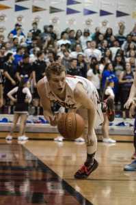 Juneau-Douglas's Bryce Swofford dives for the ball during their game against Thunder Mountain, Friday night at JDHS. Juneau-Douglas won 68-53.