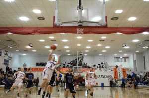 Juneau-Douglas's Erica Hurtte lays it up against Thunder Mountain's Cyrene Uddipa during their game Friday night at JDHS. Juneau-Douglas won 46-36.