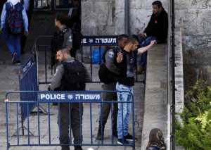 Israeli policeman frisks a Palestinian after a stabbing attack in Jerusalem on Tuesday.