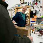 State SurplusProperty Program manager Jeff Campbell collects money during the weekly sale to the public on Wednesday.