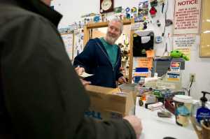 State SurplusProperty Program manager Jeff Campbell collects money during the weekly sale to the public on Wednesday.