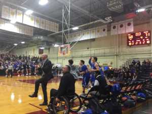 Falcons Coach John Blasco, left, celebrates as his team defeats Ketchikan High School on Thursday to advance to the finals of the Region V 4A basketball tournament.