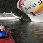 Three year old Benicio "Beni" Otto Offerson admirers cruise ships from his kayak. Photo by Paulee Offerson.