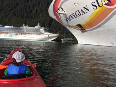 Three year old Benicio "Beni" Otto Offerson admirers cruise ships from his kayak. Photo by Paulee Offerson.