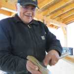 Master carver Wayne Price of Haines sharpens one of the tools he's using to carve two 40-foot spruce dugout canoes in Hoonah. (Photos by Mary Catharine Martin | Capital City Weekly)