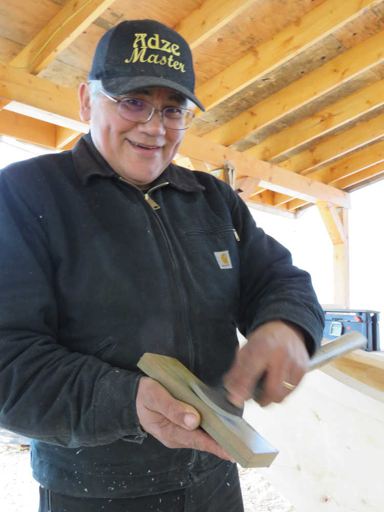 Master carver Wayne Price of Haines sharpens one of the tools he's using to carve two 40-foot spruce dugout canoes in Hoonah. (Photos by Mary Catharine Martin | Capital City Weekly)